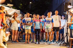 Runners pause for a moments silence before the start of the 2023 Sri Chinmoy 3100 mile race