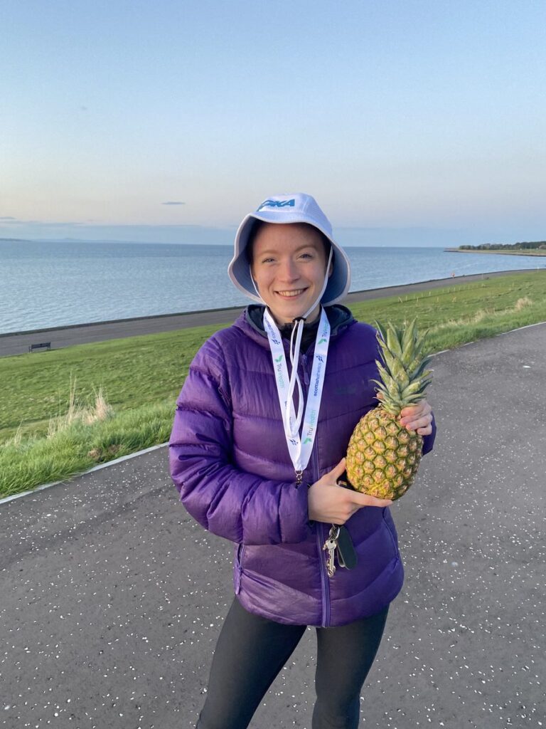 Annabel Simpson, Fife AC. Proudly holding her Pimple after winning the 2022 Sri Chinmoy5km race