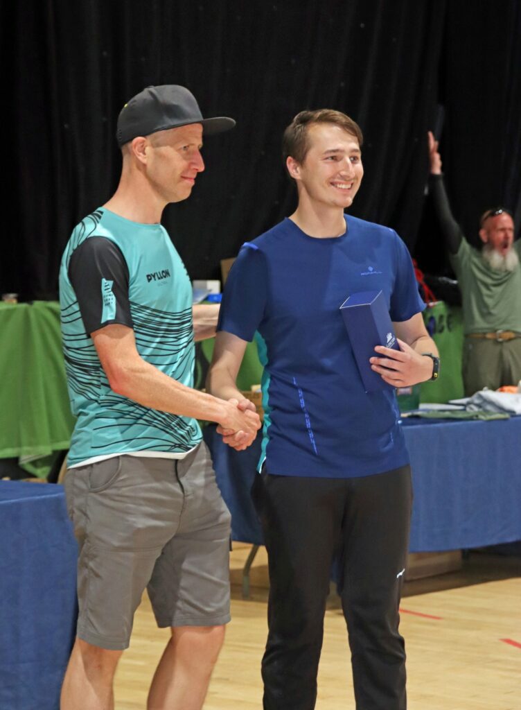 Gus irvine the winner presents final finisher Jordan Hunter with his goblet Pic Stuart MacFarlane