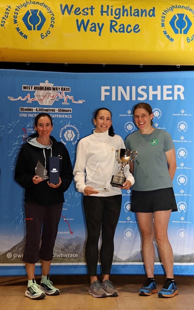 WHWay 1s 2 l-r Sophie Mullins 2nd, Roberta Fletcher 1st Jasmin Paris  on presenting duties Pic Stuart Mac Farlane 
